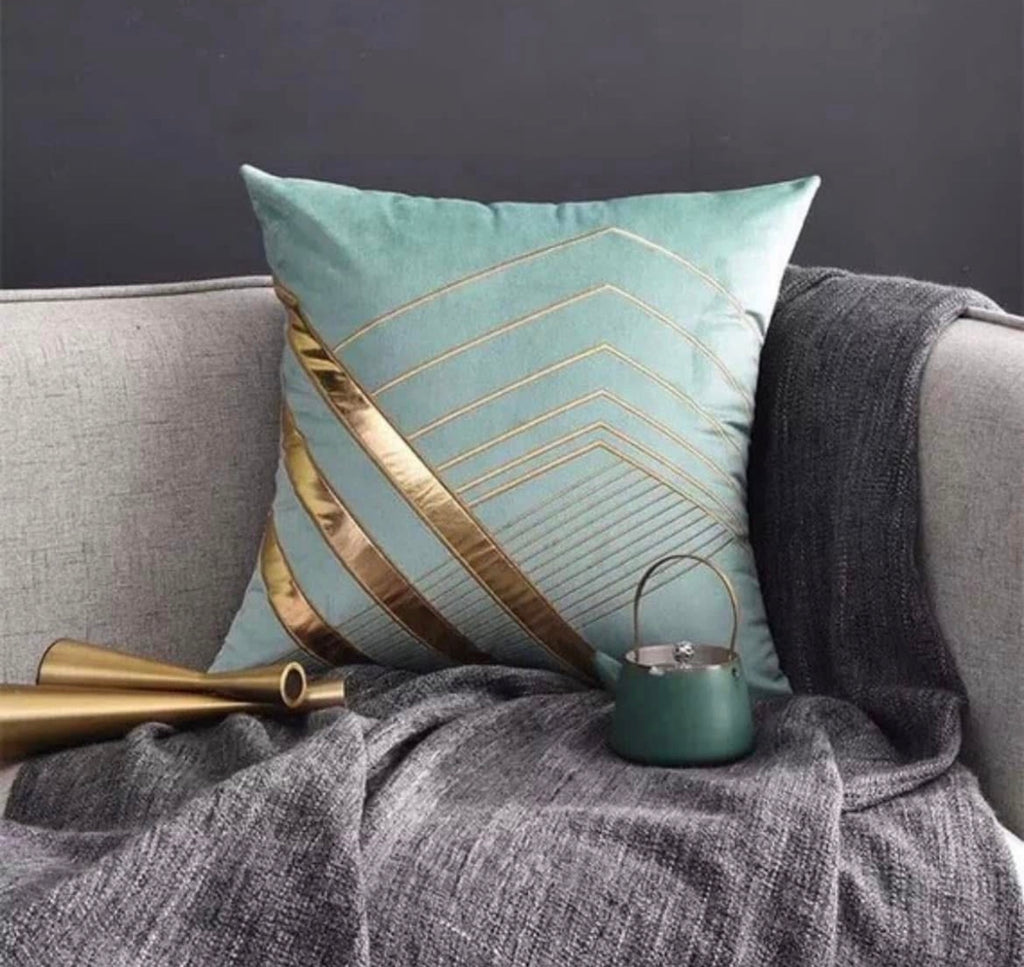 Front view of the Aqua Geo-Luxe cushion cover in soft teal velvet with a metallic gold geometric chevron pattern.