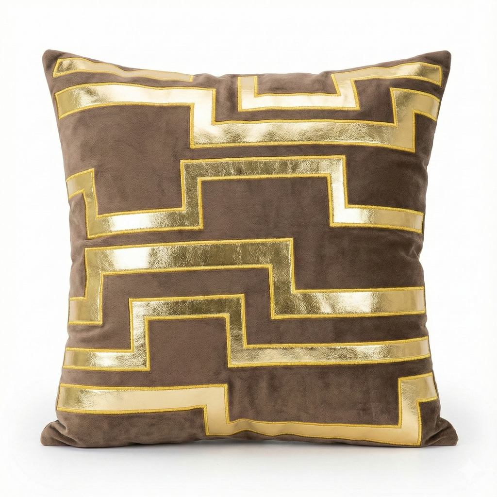 Decorative pillow with gold geometric pattern on a brown background