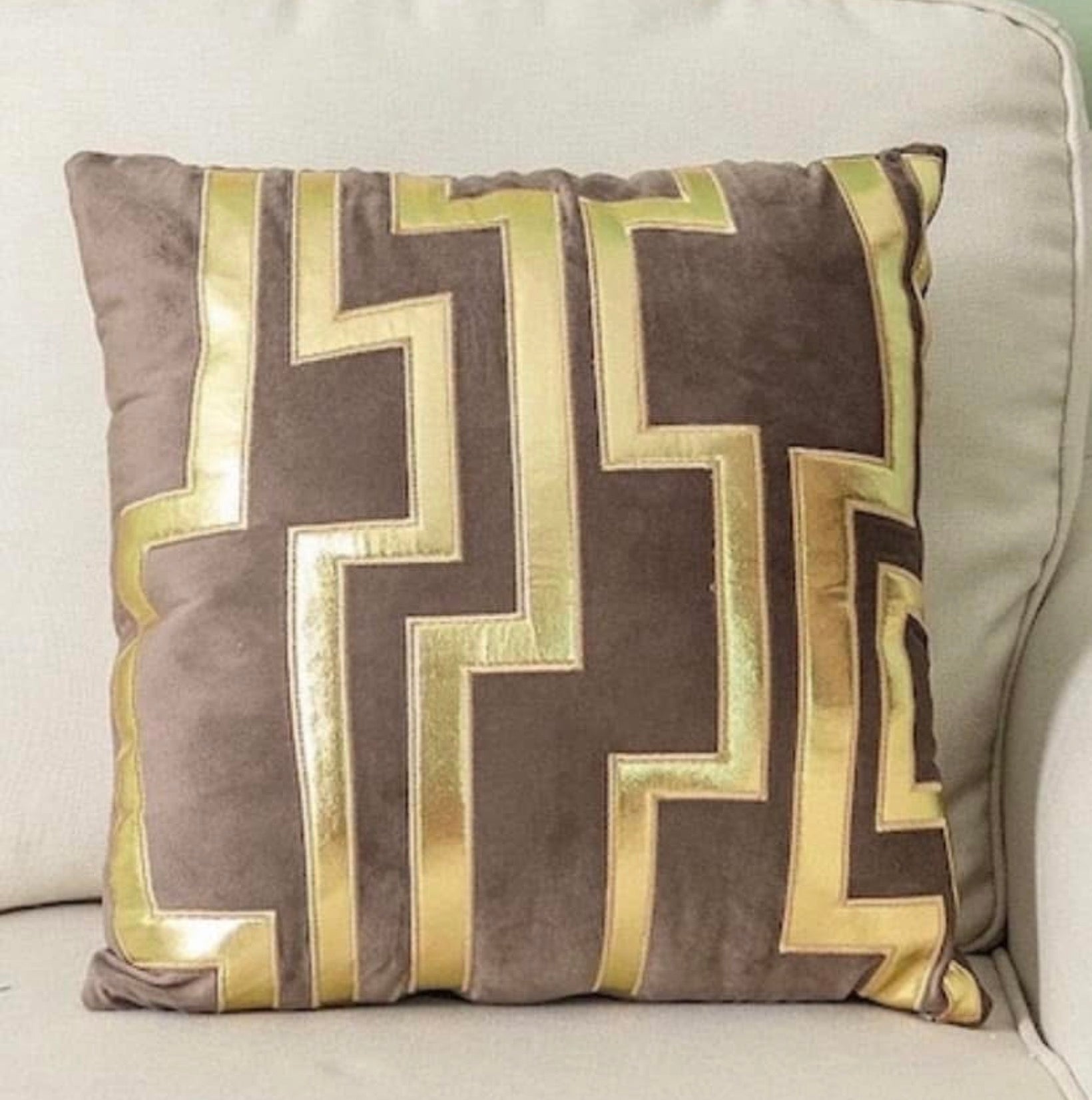 Front view of the Luxe Labyrinth cushion cover in mocha brown velvet with a metallic gold geometric maze pattern.