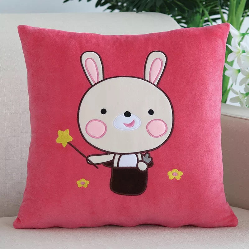 Soft pink plush nursery cushion cover featuring an embroidered cartoon bunny holding a magic wand with star details.